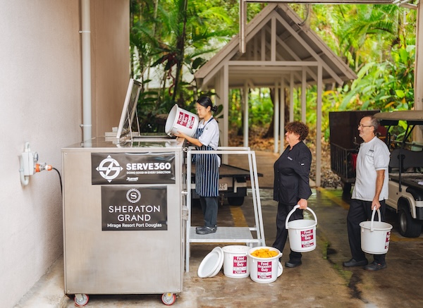 Staff at Sheraton emptying bins into composter