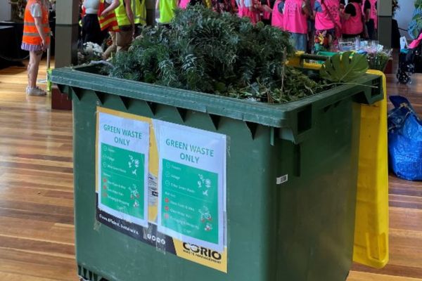 Bin with green waste and sign for vendors and exhibitors